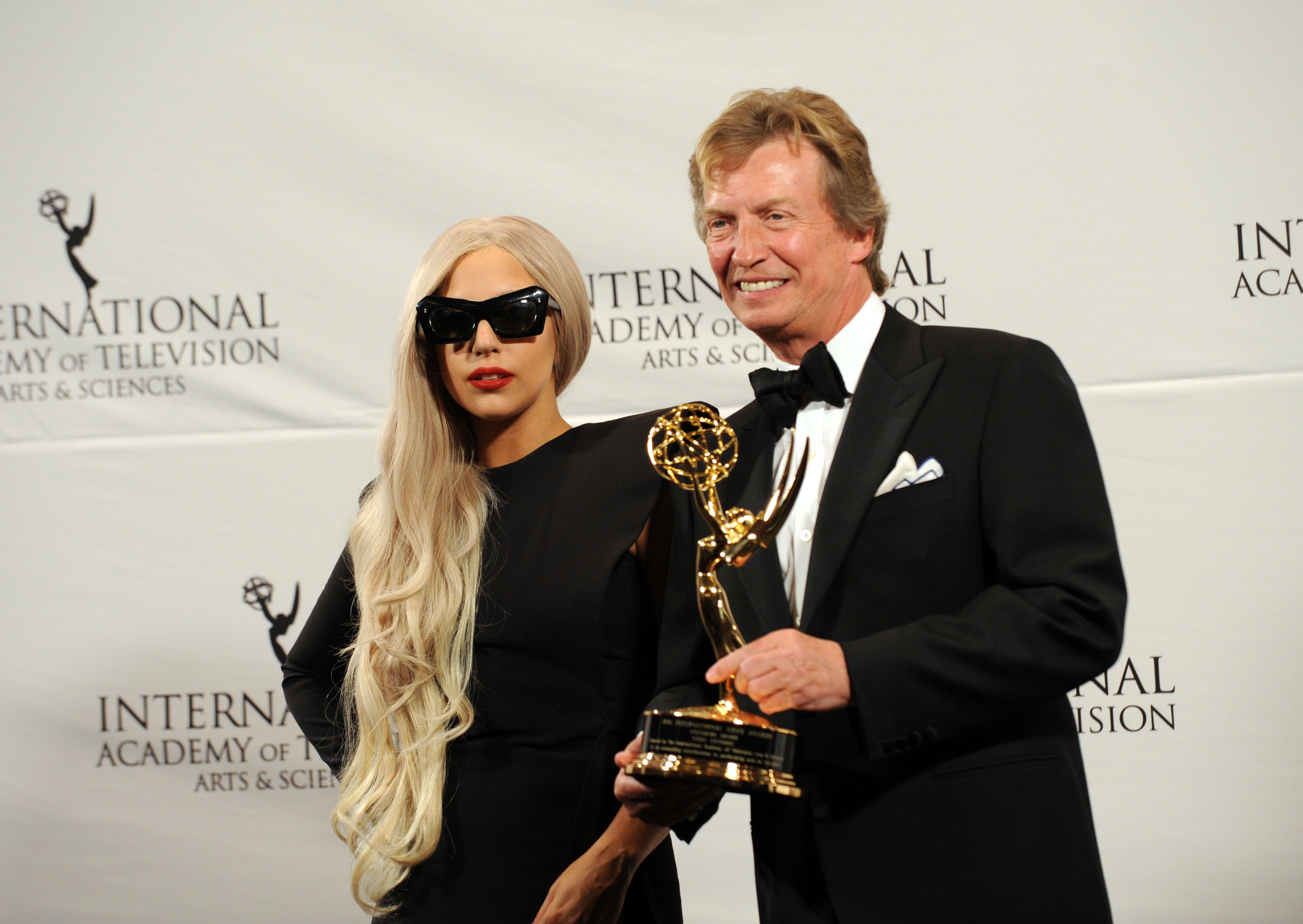 Lady Gaga stands with Nigel Lythgoe of Britain, ‘American Idol’ Executive Producer, after presenting him with The Founders Award at the 39th International Emmy Awards November 21, 2011