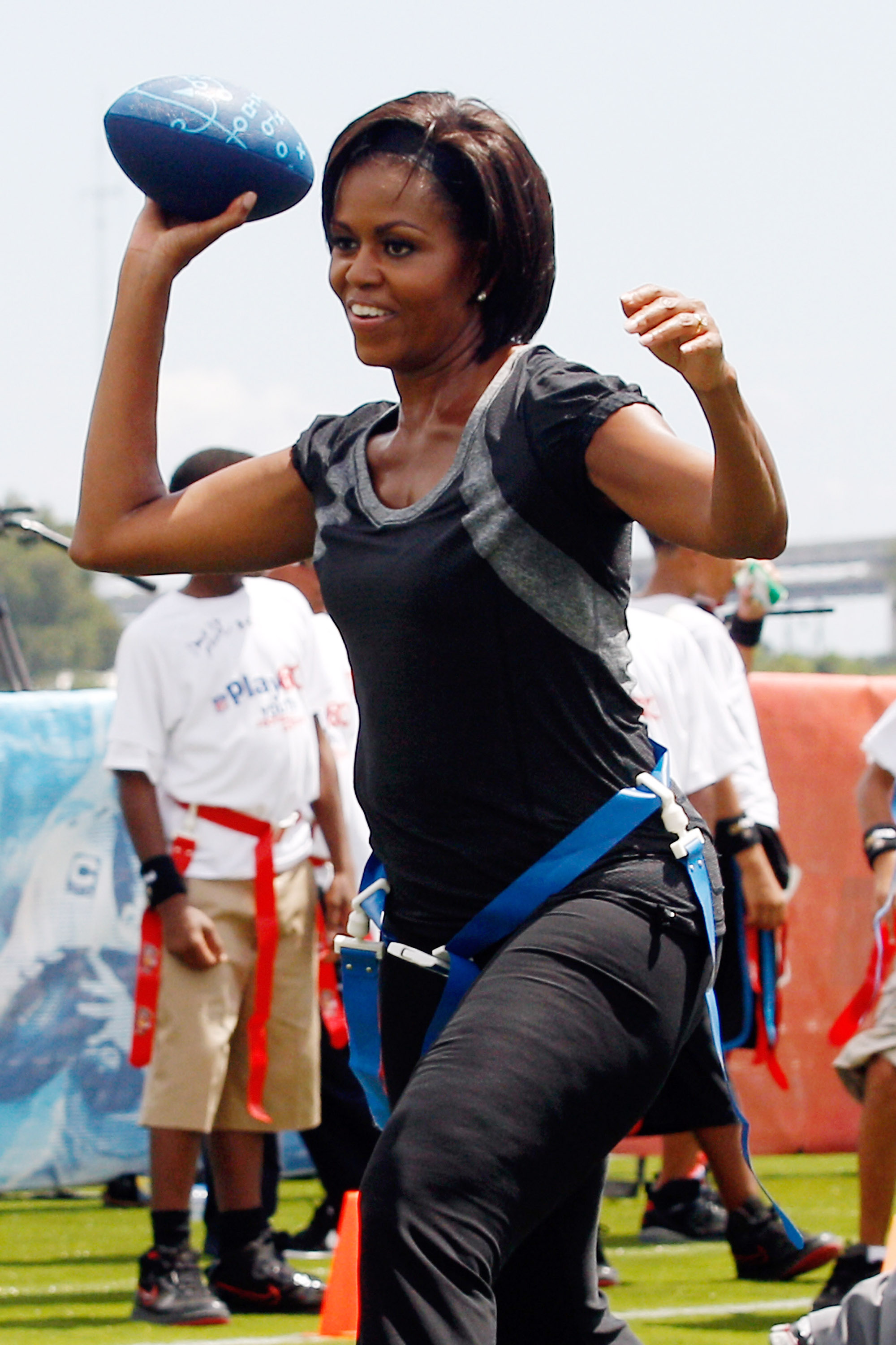 Michelle Obama throws a football at Brock Elementary School in New Orleans, Louisiana, on September 8, 2010