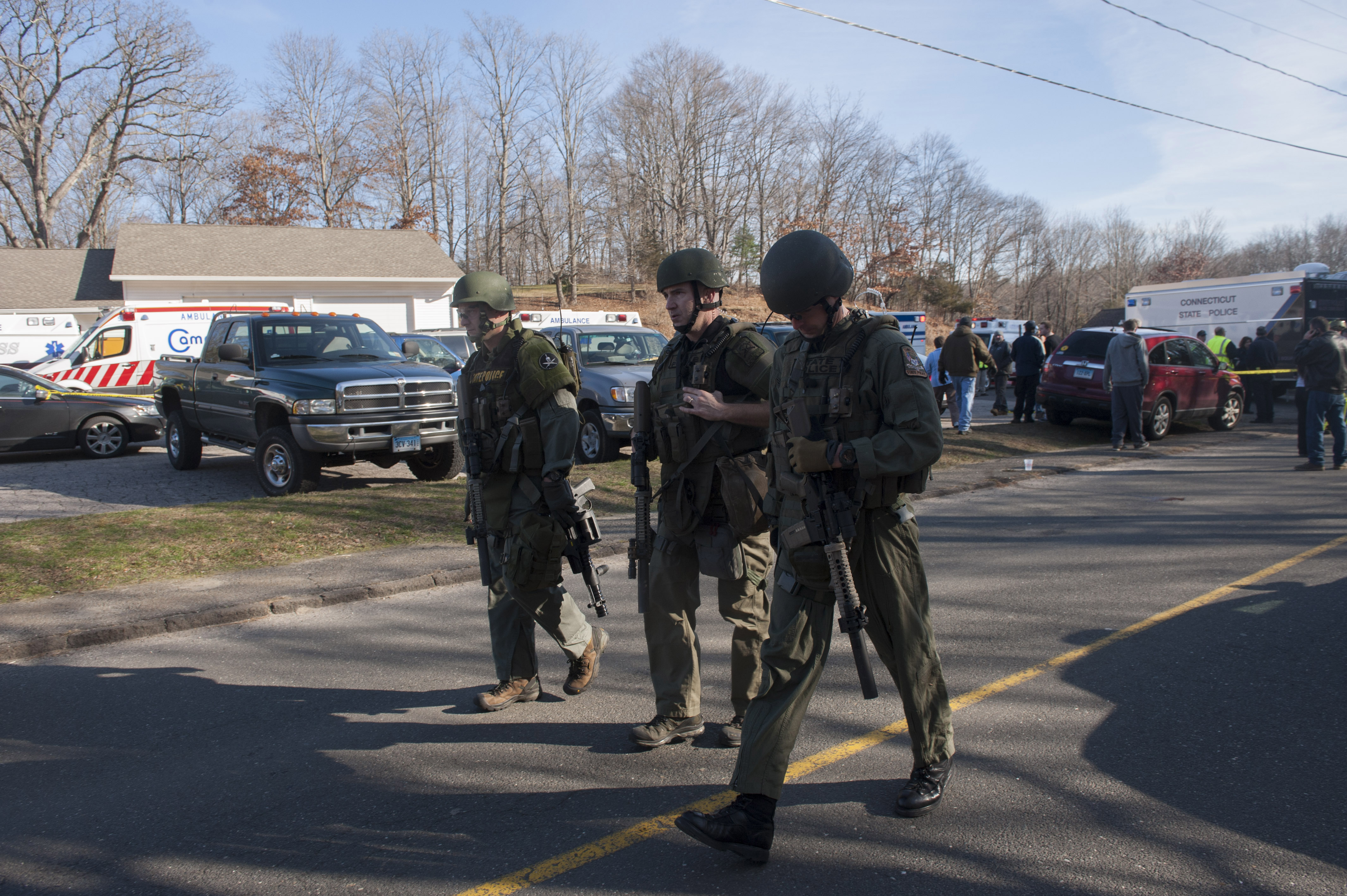 Connecticut State Police walk near the scene of an elementary school shooting on December 14, 2012 in Newtown, Connecticut