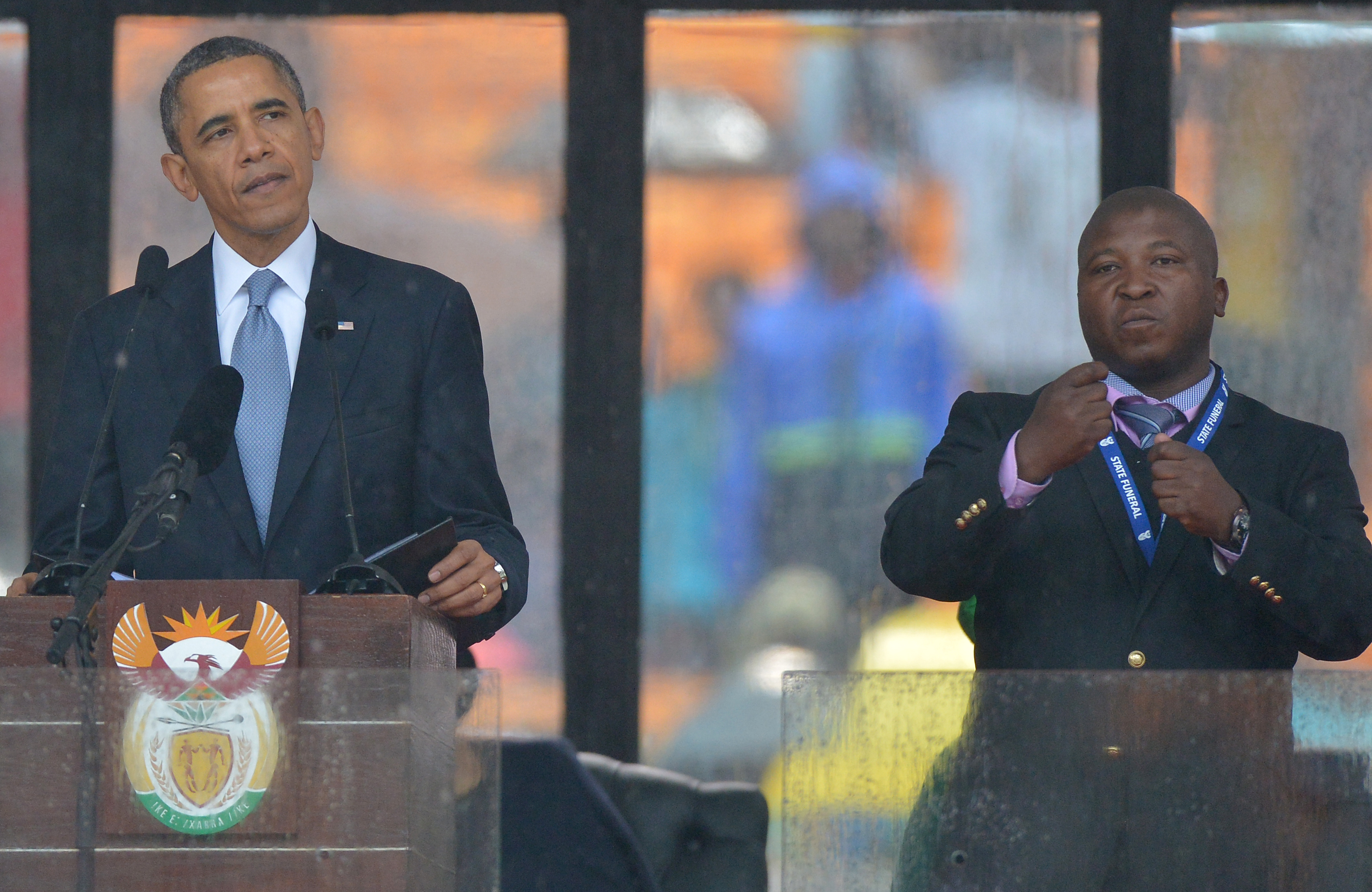 President Barack Obama is joined on stage by Thamsanqa Jantije during the Nelson Mandela Memorial in South Africa