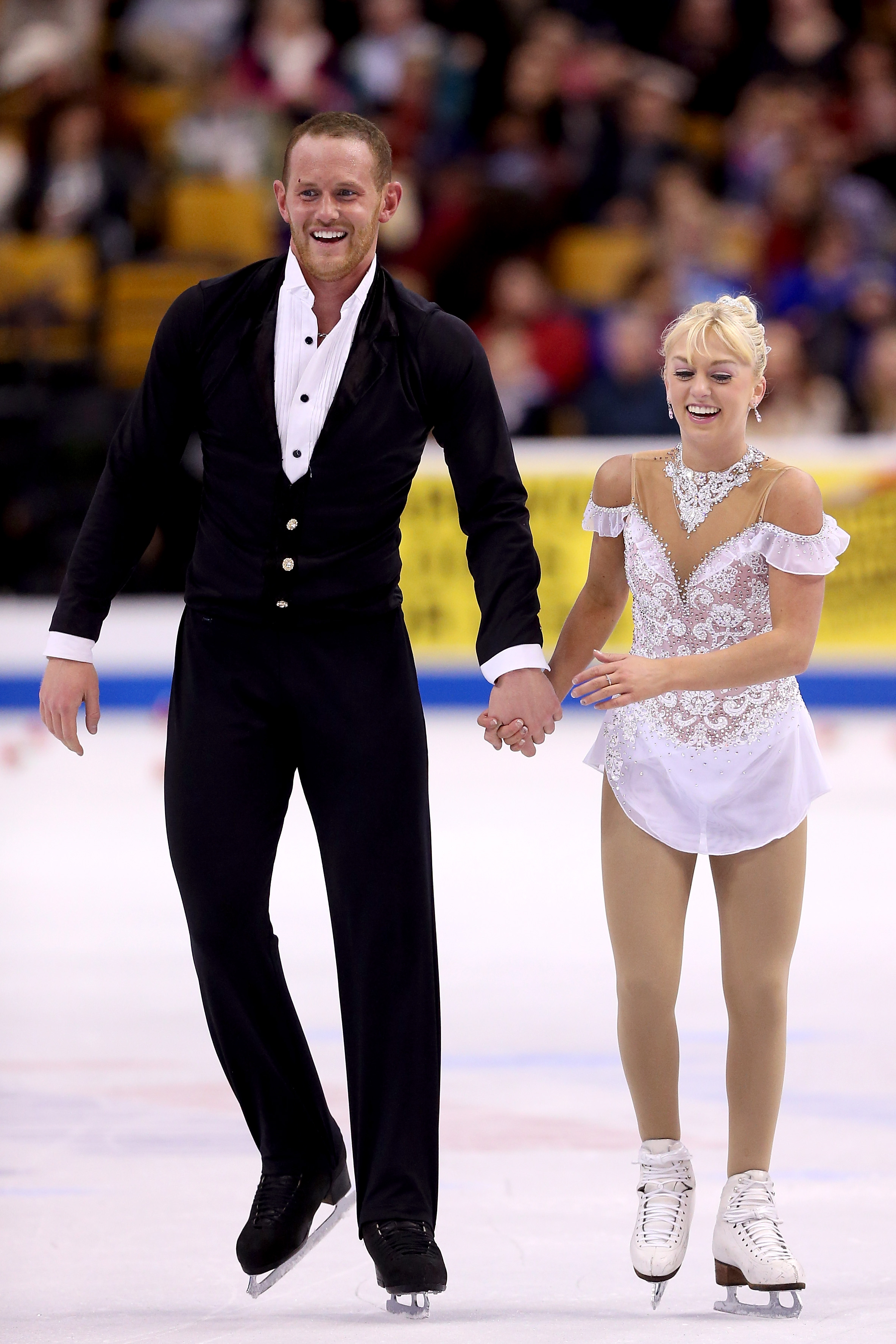 John Coughlin and Caydee Denney leave the ice after skating