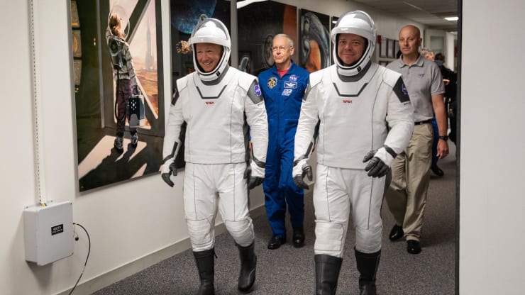 NASA astronaut Doug Hurley (left) and Bob Behnken walk out of the Neil Armstrong Operations and Checkout Building during a dress rehearsal for the SpaceX Demo-2 launch.
Credit: NASA
