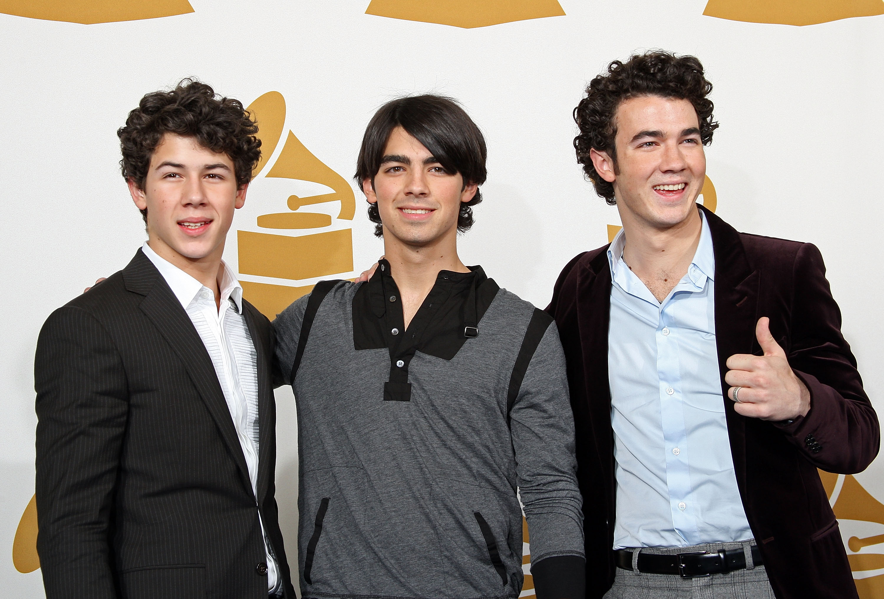 Nick Jonas, Joe Jonas, and Kevin Jonas of The Jonas Brothers pose in the press room during the Grammy Nominations concert