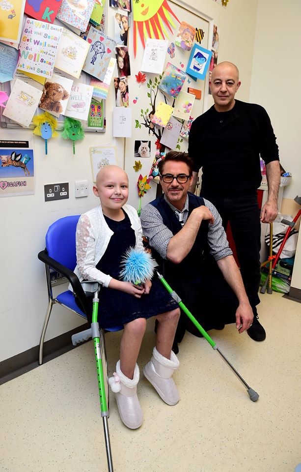 Robert Downey Jr. visits Great Ormond Street Hospital patient Denisa and her dad, Michael, in London on April 26, 2016