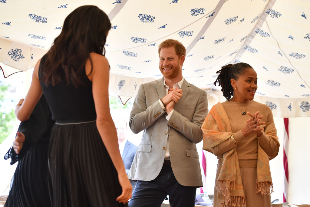 Meghan, Duchess of Sussex, Prince Harry, Duke of Sussex and Doria Ragland attend an event to mark the launch of a cookbook with recipes from a group of women affected by the Grenfell Tower fire at Kensington Palace on September 20, 2018 in London