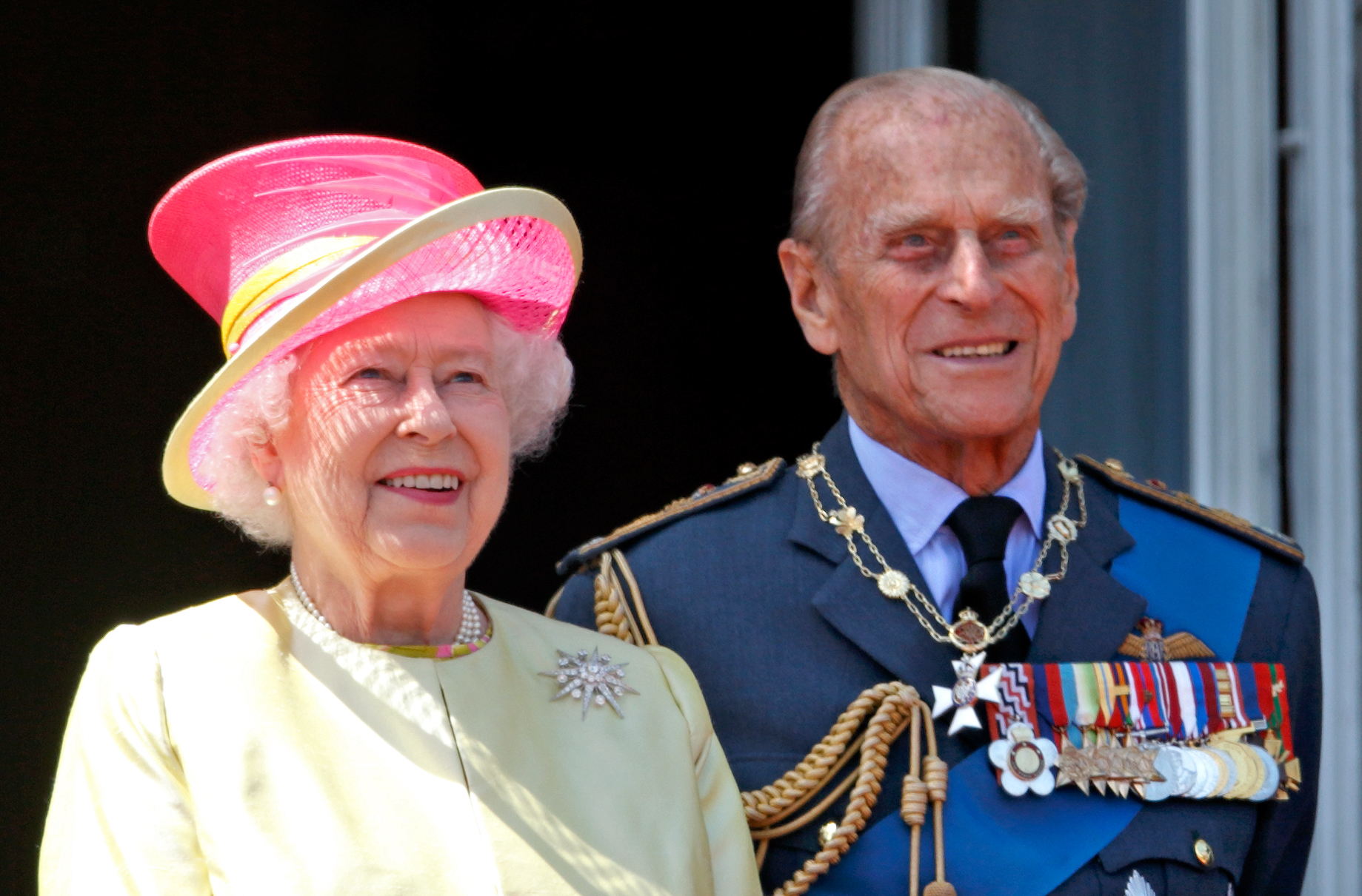 Queen Elizabeth II and Prince Philip, Duke of Edinburgh watch a flypast of Spitfire & Hurricane aircraft from the balcony of Buckingham Palace to commemorate the 75th Anniversary of The Battle of Britain on July 10, 2015 in London