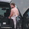 Surf's up for Liam Hemsworth as he catches waves with a friend in Malibu